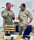 Illinois Army National Guard Maj. David Wachtveitl discusses the upcoming Command Post Exercise (CPX) with Egyptian Army Lt. Col. Mahmoud Eldeeb on Sept. 3 during Bright Star 25 at Mohamed Naguib Military Base, Egypt.