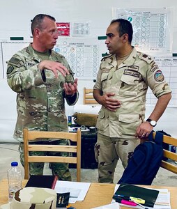 Illinois Army National Guard Maj. David Wachtveitl discusses the upcoming Command Post Exercise (CPX) with Egyptian Army Lt. Col. Mahmoud Eldeeb on Sept. 3 during Bright Star 25 at Mohamed Naguib Military Base, Egypt.