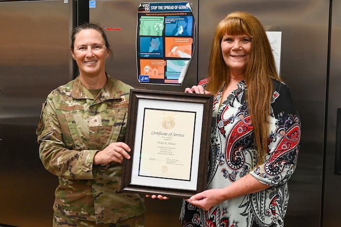 Two women hold a certificate