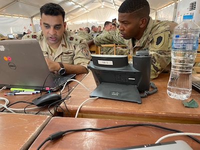 Egyptian Army Lt. Col. Raouf Mohamed discusses the upcoming Command Post Exercise (CPX) with Illinois Army National Guard Capt. Jurl Vinegar on Sept. 3 during Bright Star 25 at Mohamed Naguib Military Base, Egypt.