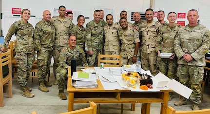 Egyptian and American colleagues pose for a group photo behind Egyptian Army Lt. Col. Mahmoud Eldeeb’s birthday cake.