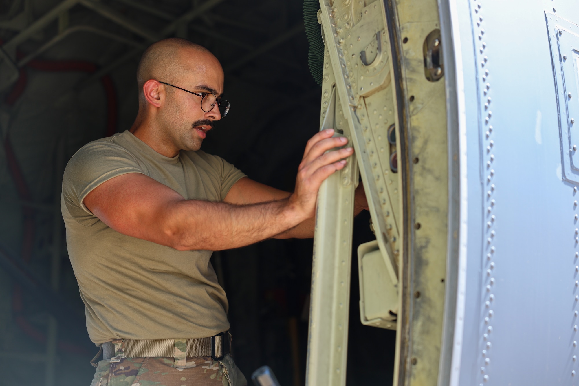 U.S. Air Force Airman in Training, assigned to the 82nd Training Wing, examines the door of a C-130 Hercules during a Bracer Forge exercise at Sheppard Air Force Base, Texas, Sept. 11, 2025.