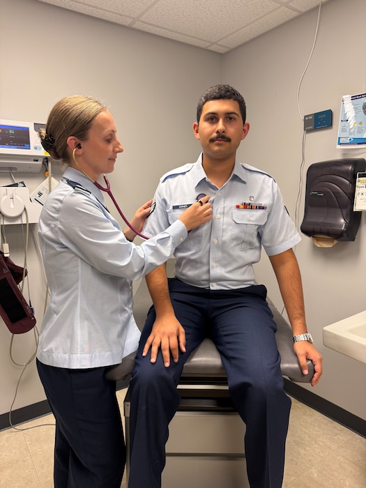 Image of an Airman treating another Airman.