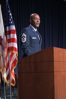 A man in an Air Force uniform speaks at a podium