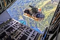 A combat rubber raiding craft (CRRC) descends from an MC-130J Commando II assigned to the 27th Special Operations Wing