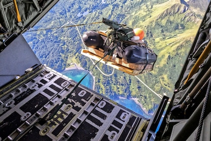 A combat rubber raiding craft (CRRC) descends from an MC-130J Commando II assigned to the 27th Special Operations Wing