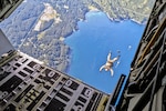 U.S. East Coast-based Naval Special Warfare Operators (SEALs) execute a free fall jump from an MC-130J Commando II assigned to the 27th Special Operations Wing