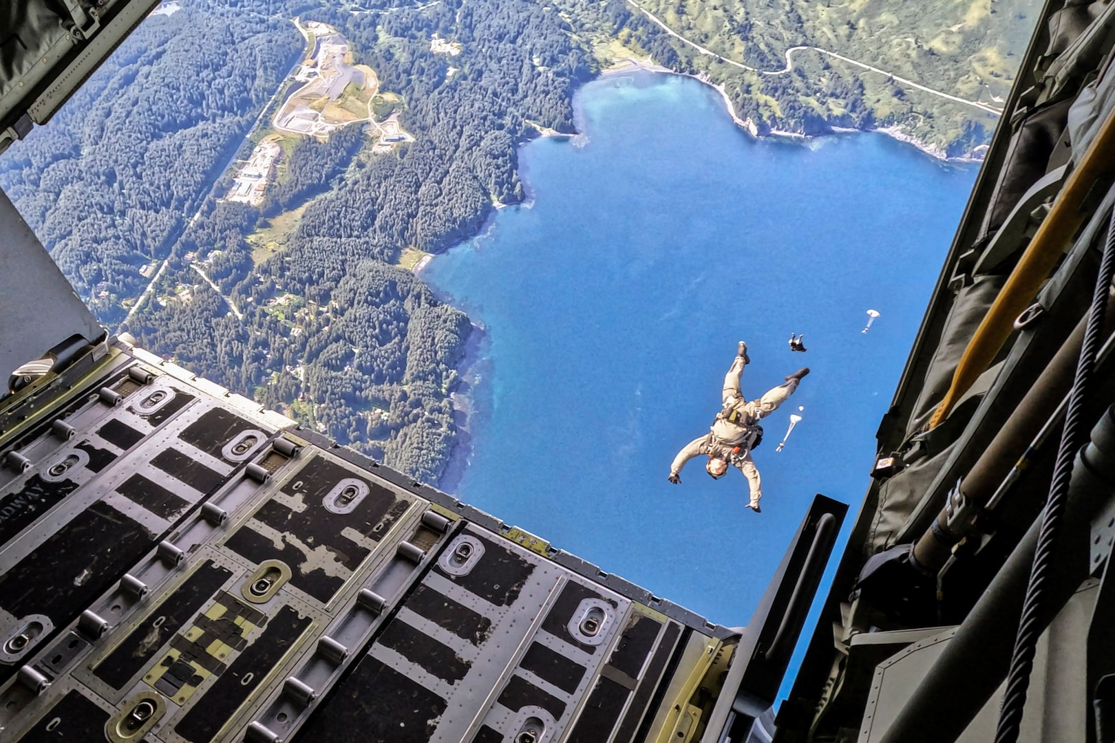 U.S. East Coast-based Naval Special Warfare Operators (SEALs) execute a free fall jump from an MC-130J Commando II assigned to the 27th Special Operations Wing
