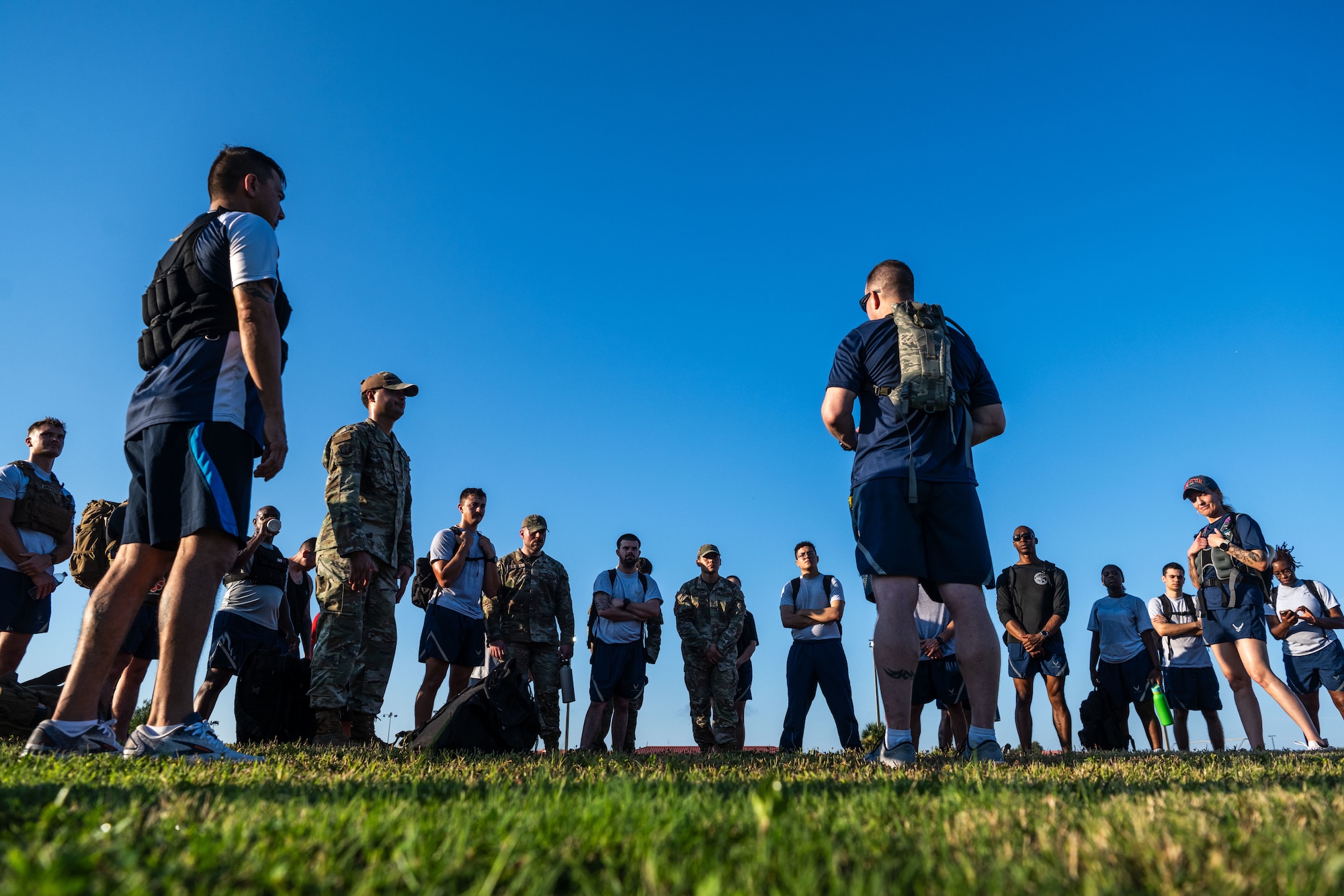U.S. Air Force Chief Master Sgt. Christopher Ottenwess, 6th Air Refueling Wing command chief, discusses the importance of physical fitness with Airman Leadership School Class 25-F students at MacDill Air Force Base, Florida, Aug. 18, 2025. During the ruck march, senior enlisted leaders from across the installation gathered to share both the physical burden and their mentorship to new first line supervisors. (U.S. Air Force photo by Senior Airman Zachary Foster)