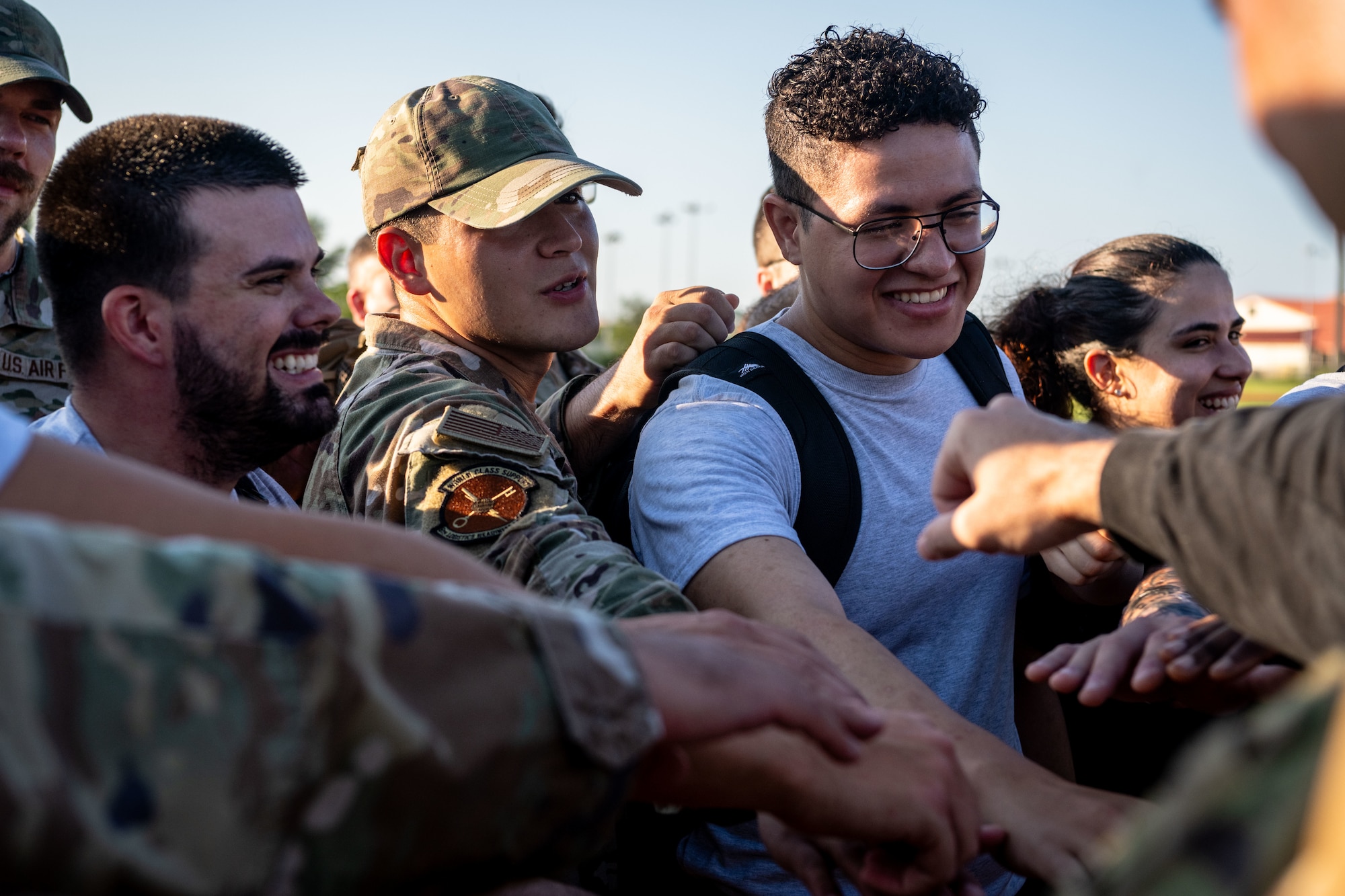 Airman Leadership School Class 25-F students come together following a ruck march at MacDill Air Force Base, Florida, Aug. 18, 2025. During the ruck march, senior enlisted leaders from across the installation gathered to share both the physical burden and their mentorship to new first line supervisors. (U.S. Air Force photo by Senior Airman Zachary Foster)