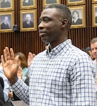 Illinois Army National Guard Spc. Adiodun Lucas recites the oath of citizenship during a naturalization ceremony Sept. 15 at the Dirksen U.S. Courthouse in Chicago. Lucas, who immigrated to the United States in 2011, enlisted in the Illinois Army National Guard in 2024.