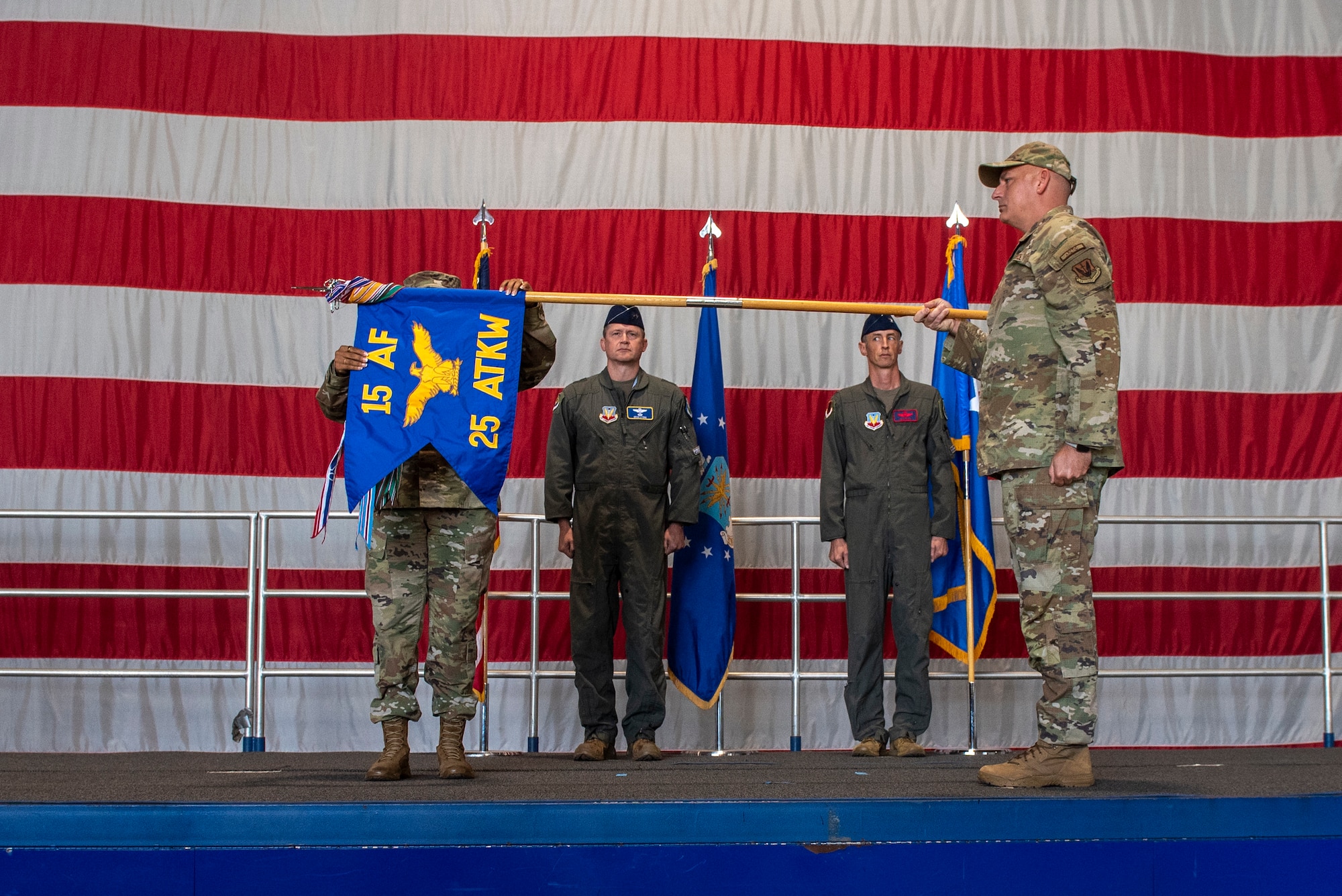 Chief Master Sgt. Nikki Drago, 15th Air Force command chief presents arms while Chief Master Sgt. Jonna Martin uncases the flag during a redesignation ceremony at Shaw Air Force Base, South Carolina, Sept. 18, 2025.