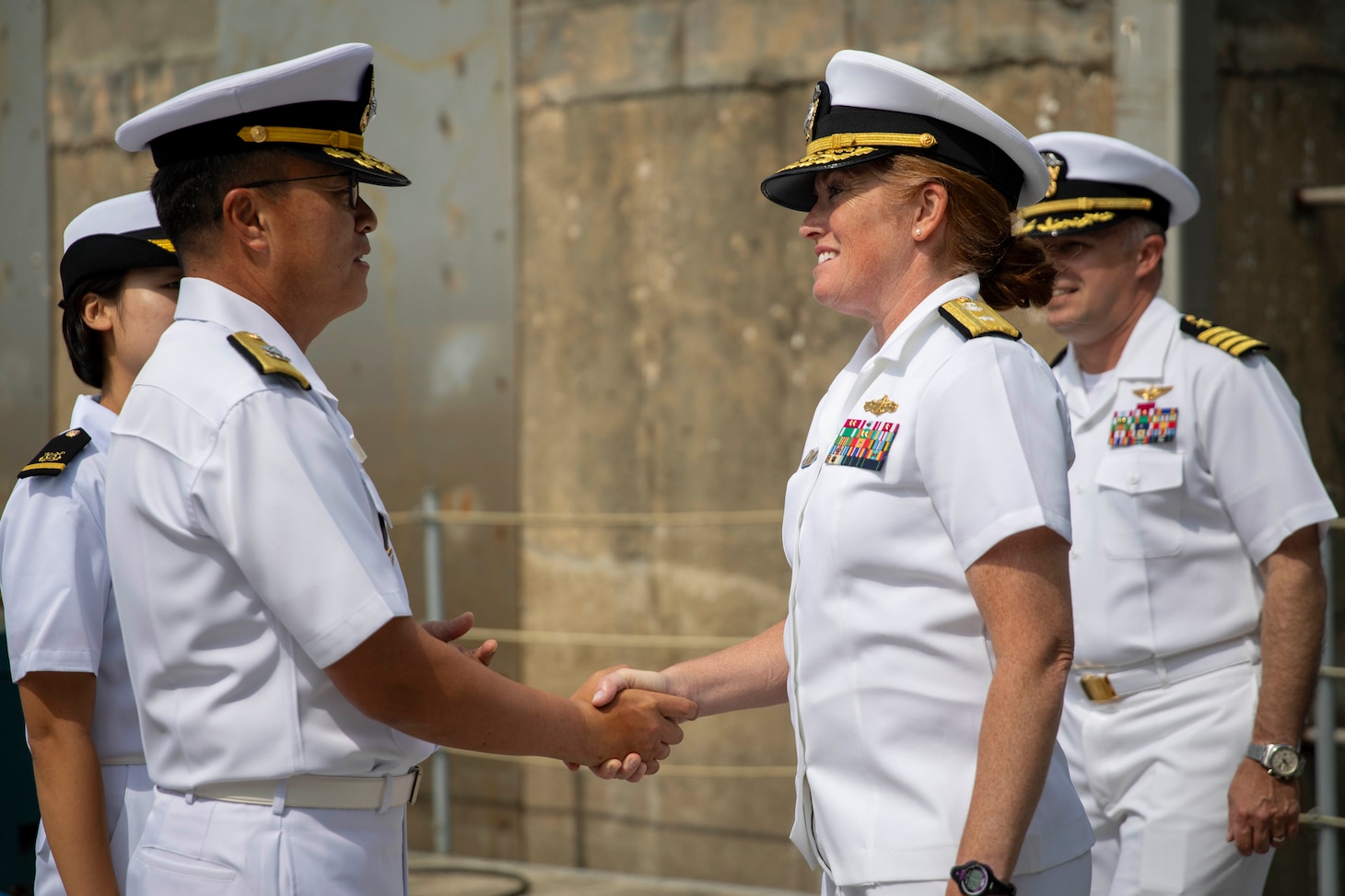 U.S. 7th Fleet Vice Commander Rear Adm. Katie Sheldon, right, greets Republic of Korea Navy 2nd Fleet Deputy Commander Rear Adm. Lee Jae-seop during a welcoming ceremony for U.S. 7th Fleet flagship USS Blue Ridge (LCC 19) in Pyeongtaek, South Korea, Sept. 18, 2025.