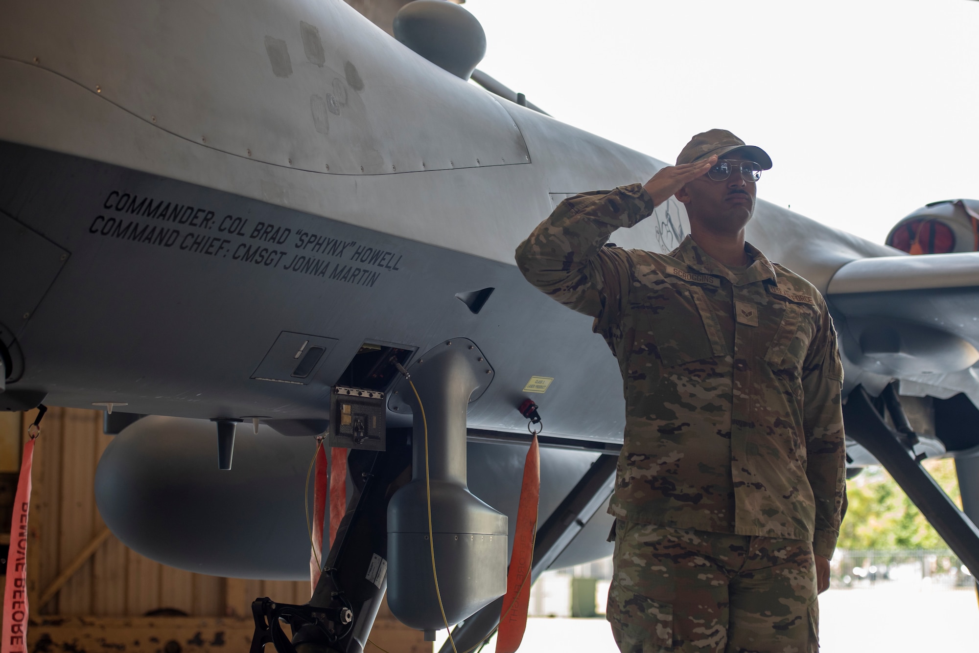 Senior Airman Stephen Scroggins from the new 25th Aircraft Maintenance Squadron reveals the commander’s and command chief’s names on the 25th Attack Wing flagship during the wing redesignation ceremony at Shaw Air Force Base, South Carolina, Sept. 18, 2025.