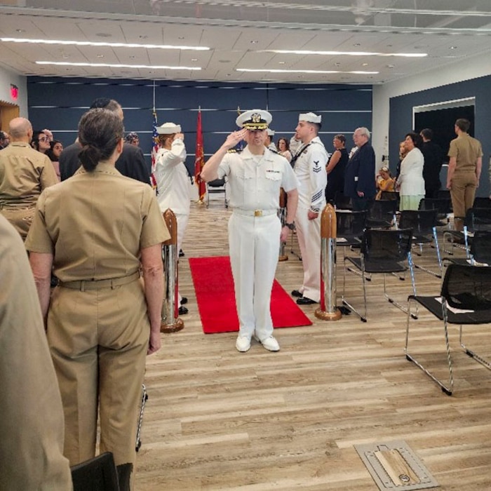 250910-O-NJ594-1180, Bethesda, Maryland, (August 22, 2025) -- Capt. Joel Sklar, oncoming officer in charge, Navy Bloodborne Infection Management Center salutes during a change of charge ceremony at United Service Organization (USO) in Bethesda, Maryland, Aug. 22, 2025. The event honored Hoffman’s accomplishments and welcomed Sklar as the new officer in charge, reaffirming the center’s role in medical readiness, force health protection, and compassionate care for service members. (U.S. Navy photo by Ai Marrero)