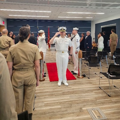 250910-O-NJ594-1180, Bethesda, Maryland, (August 22, 2025) -- Capt. Joel Sklar, oncoming officer in charge, Navy Bloodborne Infection Management Center salutes during a change of charge ceremony at United Service Organization (USO) in Bethesda, Maryland, Aug. 22, 2025. The event honored Hoffman’s accomplishments and welcomed Sklar as the new officer in charge, reaffirming the center’s role in medical readiness, force health protection, and compassionate care for service members. (U.S. Navy photo by Ai Marrero)