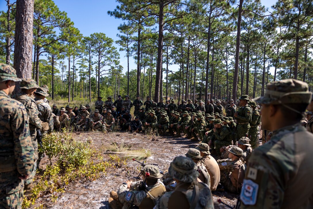 U.S. Marines with 2nd Battalion, 2nd Marine Regiment, and marines and naval infantry with, Corpo de Fuzileiros Navais (Brazilian marine corps), Cuerpo de Infantería de Marina (Chilean marine Corps), Infantería de Marina Colombiana (Colombian marine corps) and Infantería de Marina de la Armada de la República Argentina, (Naval Infantry of the Argentine Navy), get a class on patrol lanes during exercise UNITAS 2025 at Marine Corps Base Camp Lejeune, North Carolina, Sept. 17, 2025. UNITAS, which is Latin for “unity,” was conceived in 1959 and has taken place annually since first conducted in 1960. This year marks the 66th iteration of the world’s longest running annual multinational maritime exercise. (U.S. Marine Corps photo by Lance Cpl. Payton Goodrich)