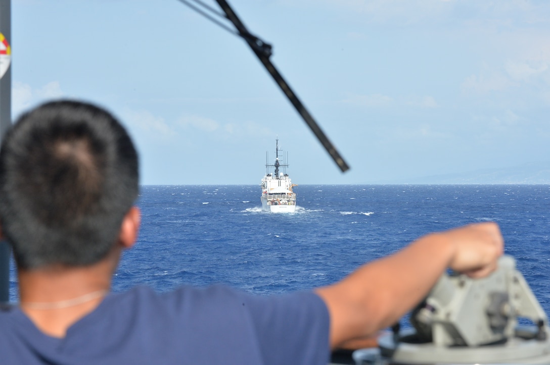 A crew member maintains a lookout watch from the Coast Guard Cutter Alert (WMEC 630) during detainee transfers with the Coast Guard Cutter Spencer (WMEC 905) off the coast of Puerto Rico, Aug. 11, 2025. During their patrol, Alert’s crew conducted 10 transfers of illicit contraband and detainees in under two weeks. (U.S. Coast Guard photo by Ensign Nicholas Reeser)