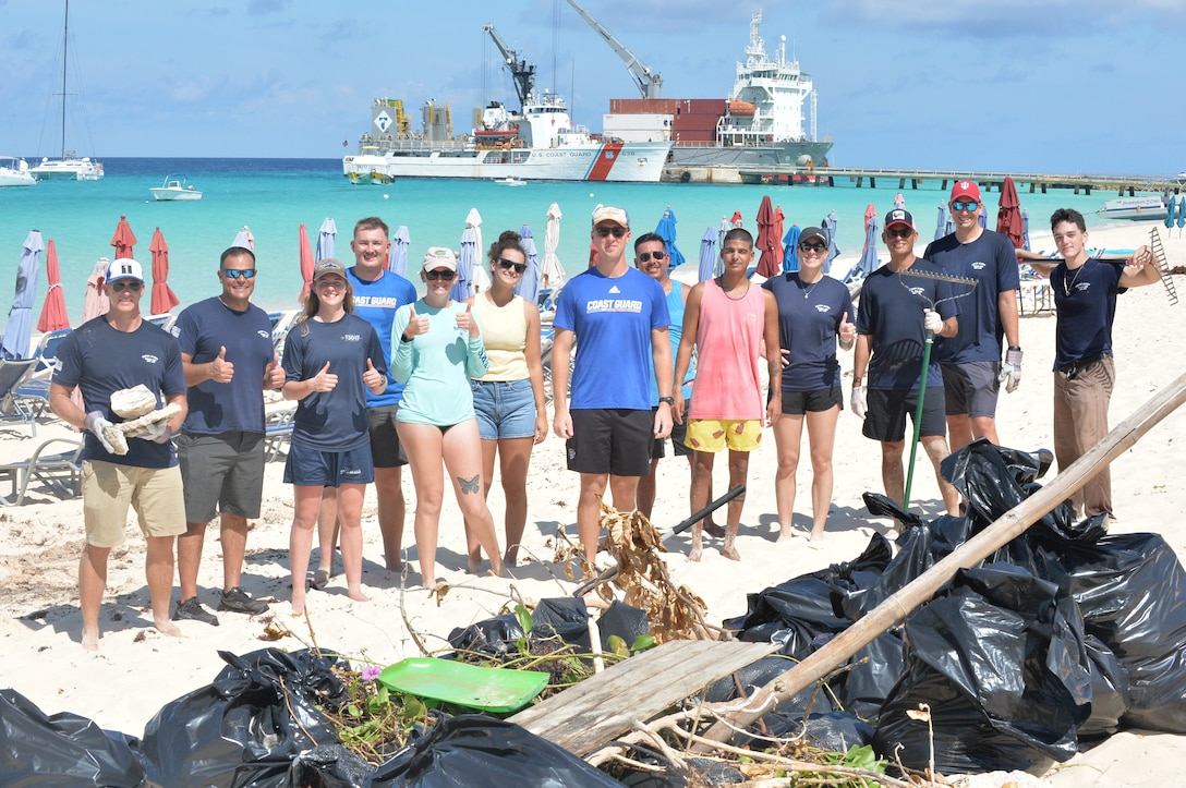 Crewmembers from the Coast Guard Cutter Alert (WMEC 630) take a group photo during a beach cleanup in the Turks and Caicos Islands, Sept. 2, 2025. Alert’s crew assisted members from the Turks and Caicos Islands Department of Disaster Management & Emergencies by removing trash and unwanted materials that had washed up during Tropical Storm Erin. (U.S. Coast Guard photo by Ensign Nicholas Reeser)