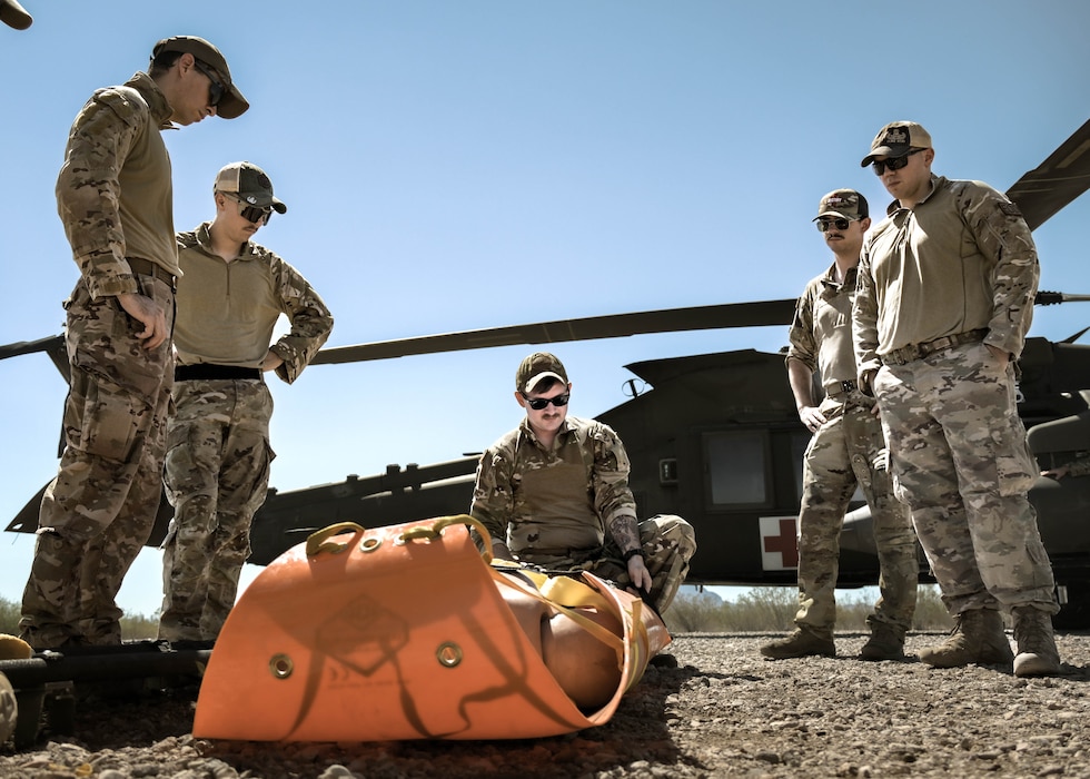 U.S Army Staff Sgt. Cody Solomon, a flight paramedic assigned to Charlie Company, 2nd General Support Aviation Battalion, 1st Aviation Regiment, 1st Combat Aviation Brigade, 1st Infantry Division, instructs Explosive Ordnance Disposal Airmen assigned to the 56th Fighter Wing on hoist training