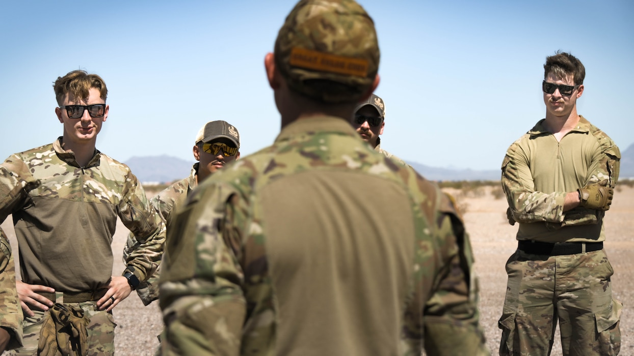 U.S. Air Force Explosive Ordnance Disposal airmen assigned to the 56th Fighter Wing listen to feedback on a joint exercise