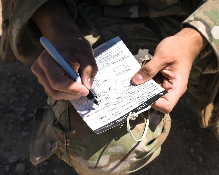 U.S. Air Force Senior Airman Elias Saavedra, 56th Civil Engineer Squadron explosive ordnance disposal technician, fills out a tactical combat casualty care card
