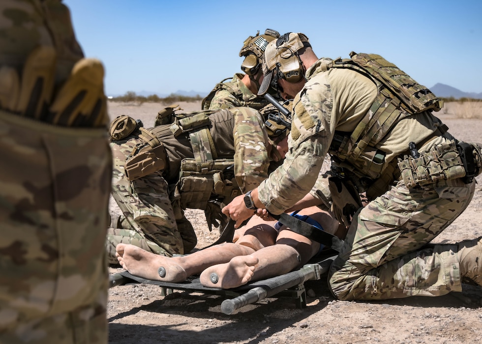 U.S. Air Force explosive ordnance disposal Airmen assigned to the 56th Civil Engineer Squadron, assess and secure a rescue manikin to a stretcher