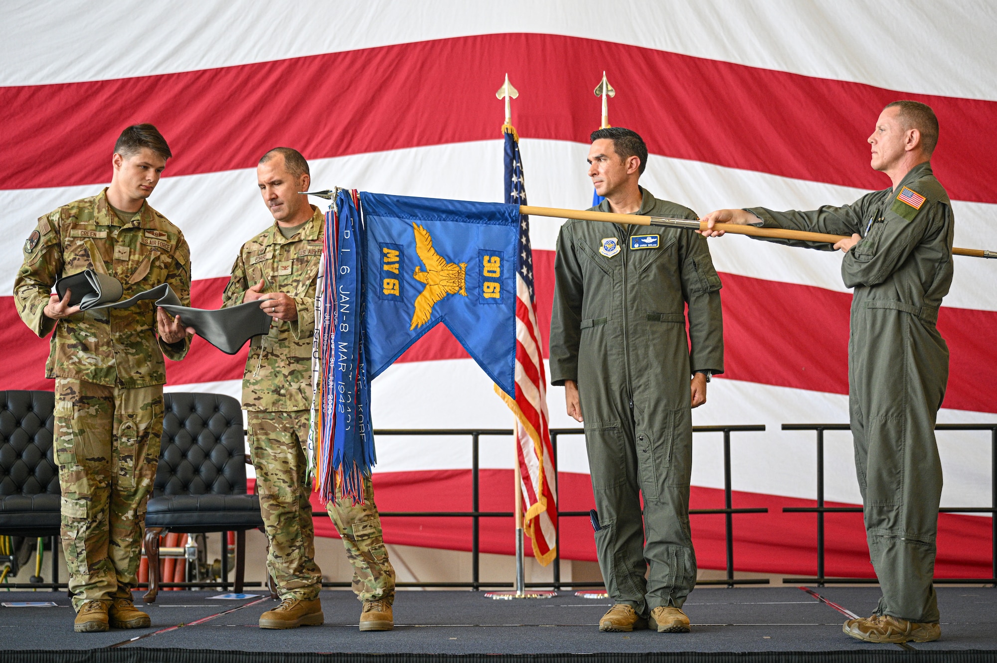 U.S. Air Force Airmen assigned to the 19th Airlift Wing encase the 19th Operations Group guidon during an inactivation ceremony at Little Rock Air Force Base, Arkansas, Sept. 18, 2025.  The 19th Operations Support Squadron, 41st Airlift Squadron and the 61st Airlift Squadron were officially reassigned to the 19th AW.