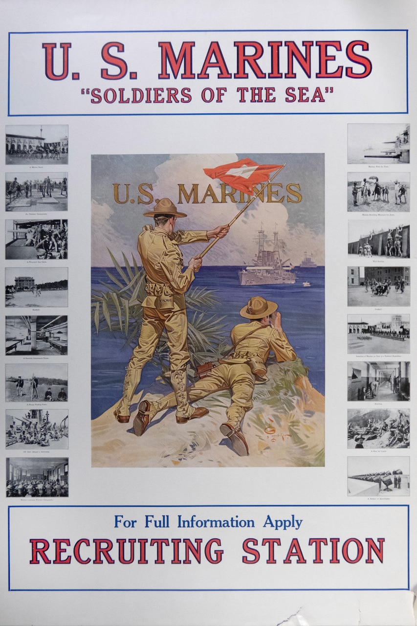 A Marine on a hill signal flags a ship while another Marine looks at the ship through binoculars.