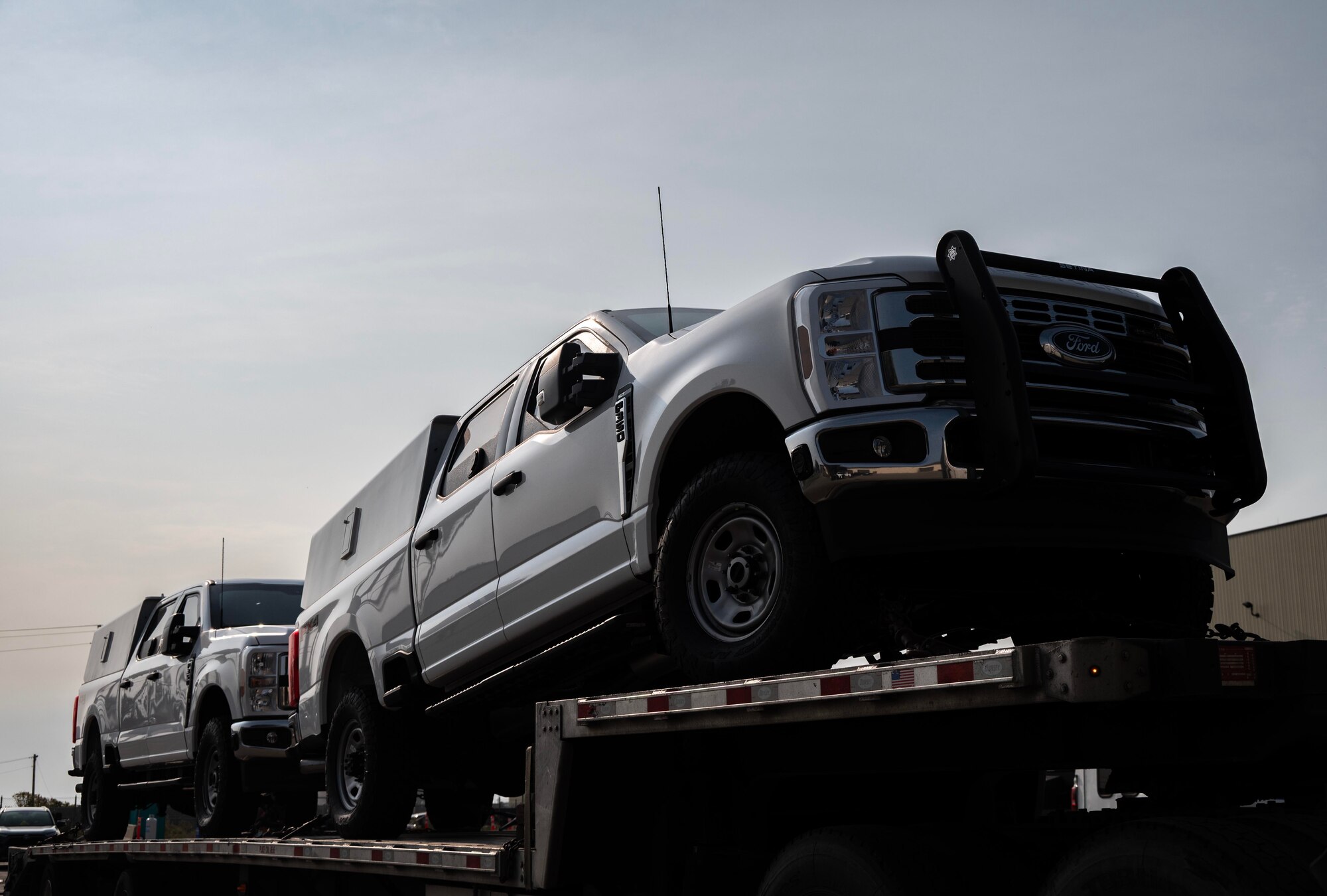 Up-armored Ford F-350s are delivered to Minot Air Force Base, North Dakota, Sept. 8, 2025. To enhance safety, efficiency and sustainability for defenders, the installation is set to receive these vehicles over the next two years as part of the phased replacement of Bearcats and Humvees. (U.S. Air Force photo by Senior Airman Alyssa Bankston)