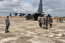 Sri Lanka Air Force members carry a litter with a simulated patient from a C-130 Hercules as Royal Australian Air Force Corporal Georgia Smith, left, Joint Health Command medical technician, evaluates during a Pacific Angel 25-1 mass casualty exercise at Katunayake Air Base, Sri Lanka, Sept. 11, 2025.