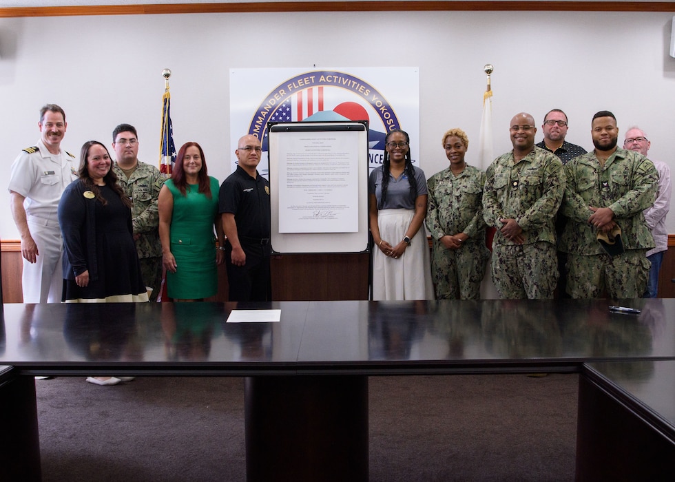 Cmdr. Patrick Gutierrez, Commander, Fleet Activities Yokosuka (CFAY) Chief Staff Officer, joins members of the CFAY Emergency Management Office and CFAY Fleet and Family Readiness (FFR) Department for a group photo following a National Preparedness Month Proclamation Signing in the CFAY headquarters conference room Thursday, September 11, 2025.