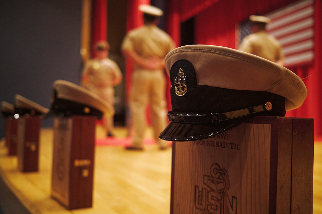Shadow boxes rest on the stage in front of sideboys at the Chief Petty Officer Pinning Ceremony in Commander, Fleet Activities Yokosuka's (CFAY) Fleet Theater Tuesday, September 16.