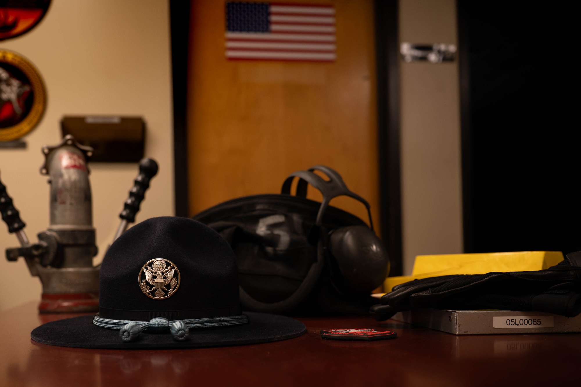 U.S. Air Force military training instructor hat rests on a desk alongside equipment used by petroleum, oils and lubricants Airmen