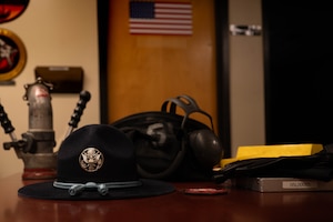 U.S. Air Force military training instructor hat rests on a desk alongside equipment used by petroleum, oils and lubricants Airmen
