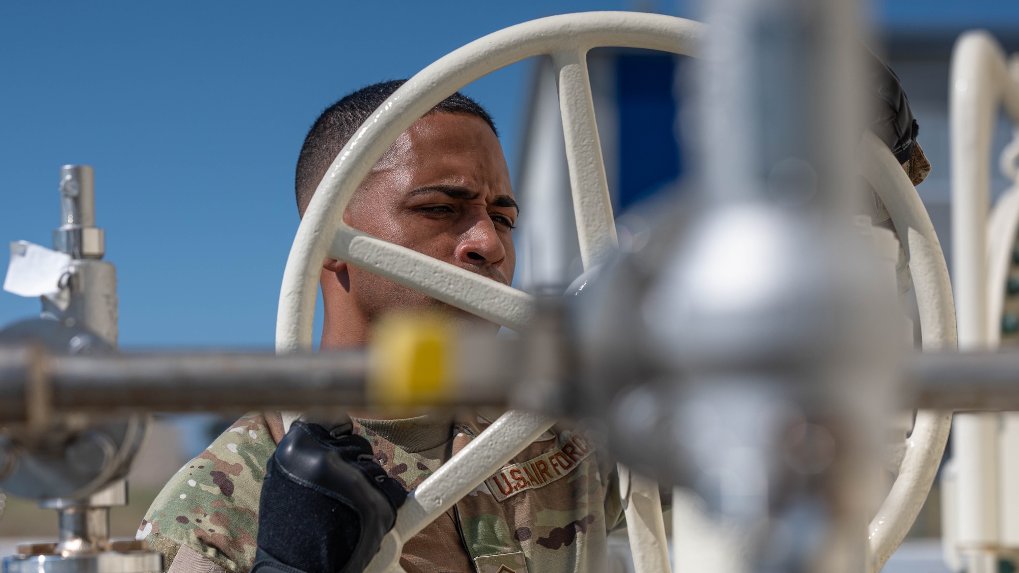 U.S. Air Force Master Sgt. Brandon Vazquez, 325th Logistics Readiness Squadron Petroleum, Oils and Lubricants section chief, opens a fuel line