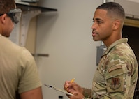 U.S. Air Force Master Sgt. Brandon Vazquez, 325th Logistics Readiness Squadron Petroleum, Oils and Lubricants section chief, performs an inspection of a fuel sample