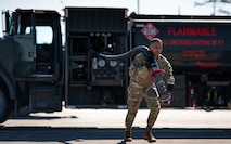 U.S. Air Force Master Sgt. Brandon Vazquez, 325th Logistics Readiness Squadron Petroleum, Oils and Lubricants section chief, pulls a fuel hose