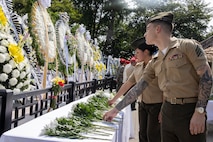 U.S. Marine Corps Sgt. Russel Gannard, a data systems administrator, and Sgt. Gabriel Gonzalez an operations clerk, both with U.S. Marine Corps Forces Korea, place flowers down in honor of the fallen during a floral tribute event commemorating the 75th anniversary of the landing at Incheon, in Incheon, South Korea, Sept. 15, 2025. The commemoration honored the strategic success of the landing, which turned the tide of the Korean War, and paid tribute to the sacrifices made by Republic of Korea and United Nations Command Forces. (U.S. Marine Corps photo by Cpl. Simon Saravia)