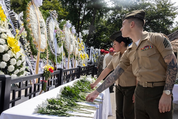U.S. Marine Corps Sgt. Russel Gannard, a data systems administrator, and Sgt. Gabriel Gonzalez an operations clerk, both with U.S. Marine Corps Forces Korea, place flowers down in honor of the fallen during a floral tribute event commemorating the 75th anniversary of the landing at Incheon, in Incheon, South Korea, Sept. 15, 2025. The commemoration honored the strategic success of the landing, which turned the tide of the Korean War, and paid tribute to the sacrifices made by Republic of Korea and United Nations Command Forces. (U.S. Marine Corps photo by Cpl. Simon Saravia)