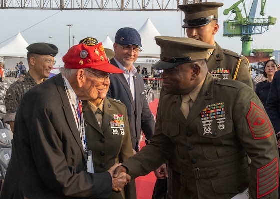 U.S. Marine Corps Sgt. Maj. Ismael J. Bamba, command senior enlisted Leader of U.S. Marine Corps Forces Korea, shakes hands with Pfc. Rudy Meekins, a veteran of the Korean War, during a ceremony commemorating the 75th anniversary of the landing at Incheon, in Incheon, South Korea, Sept. 15, 2025. The commemoration honored the strategic success of the landing, which turned the tide of the Korean War, and paid tribute to the sacrifices made by ROK and United Nations Command forces. (U.S. Marine Corps photo by Cpl. Simon Saravia)