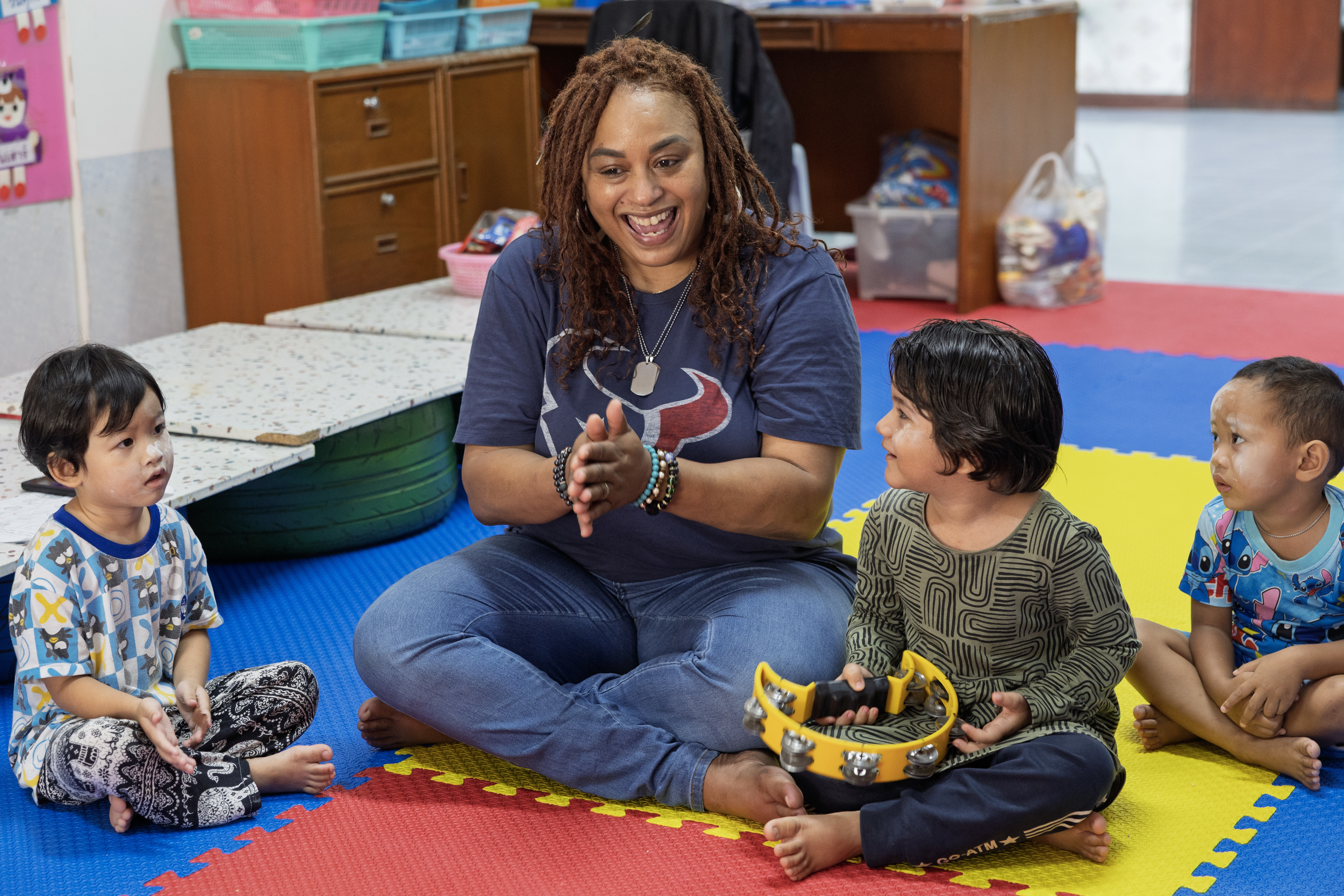 Civilian mariner Christa Wilson, 2nd Cook, assigned to Lewis and Clark-class dry cargo ship USNS Amelia Earhart (T-AKE 6), interacts with children of the Fountain of Life Children’s Center in Pattaya, Thailand, during a community outreach event, Sept. 10.