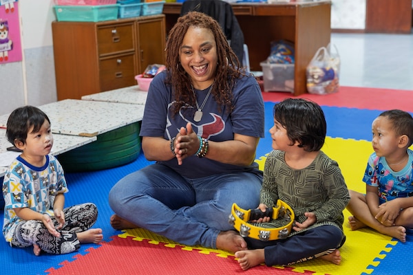 Civilian mariner Christa Wilson, 2nd Cook, assigned to Lewis and Clark-class dry cargo ship USNS Amelia Earhart (T-AKE 6), interacts with children of the Fountain of Life Children’s Center in Pattaya, Thailand, during a community outreach event, Sept. 10.