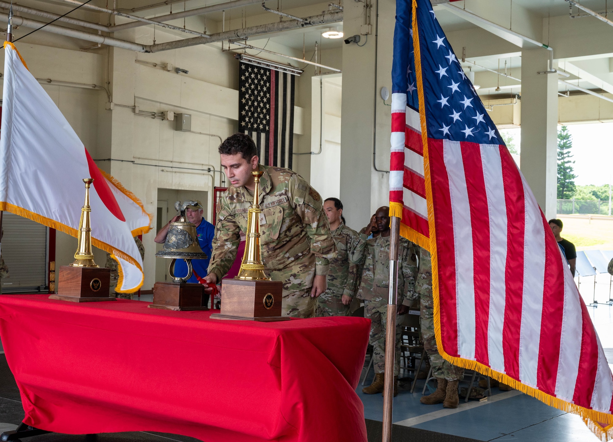 Service member rings the bell during ceremony.