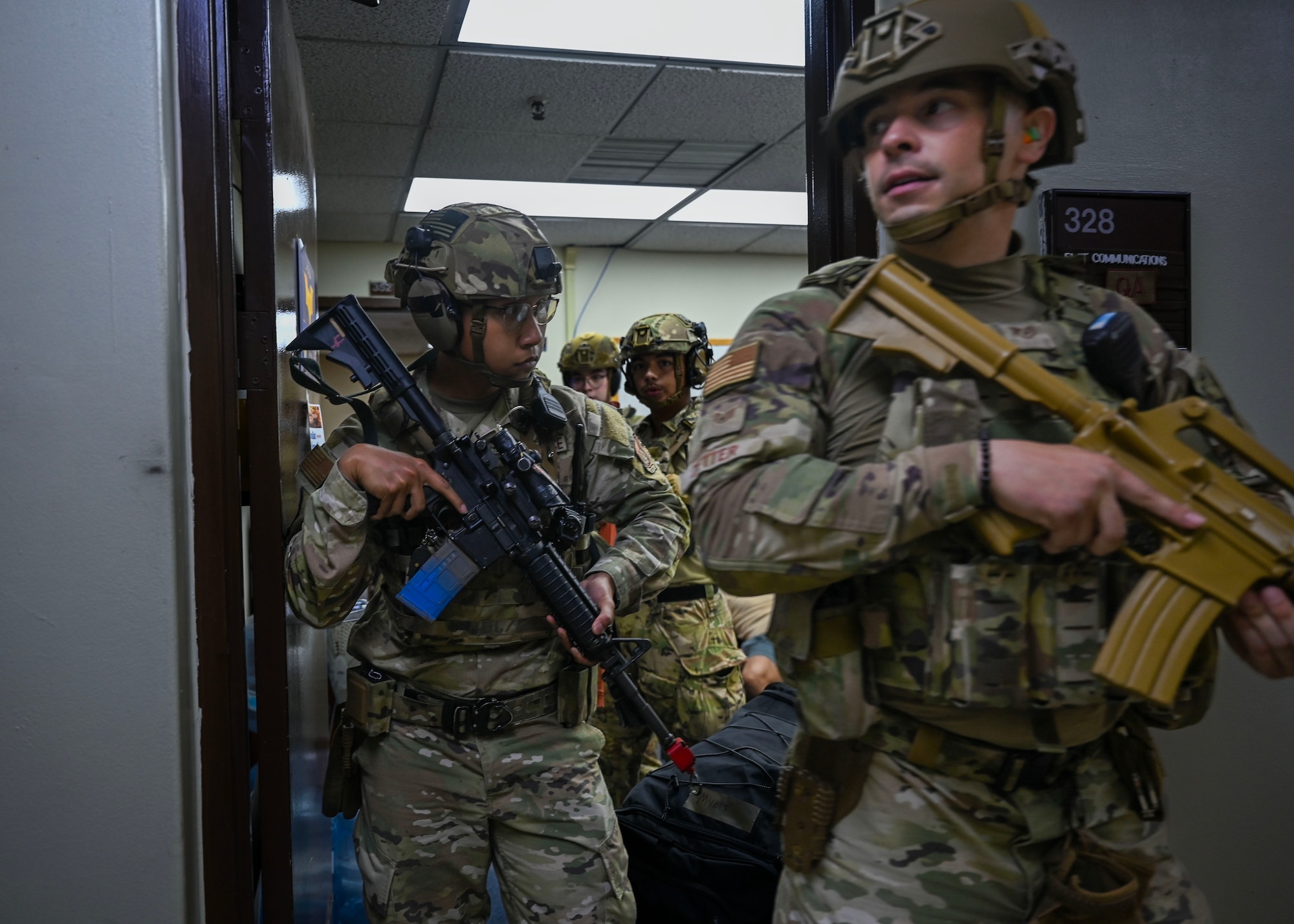 Defenders assigned to the 51st Security Forces Squadron leave a room after neutralizing a simulated threat during an active shooter exercise at Osan Air Base, Republic of Korea, Sept. 18, 2025. The exercise tested teamwork, communication, and coordination with base-wide emergency response agencies. (U.S. Air Force photo by Staff Sgt. Sarah Williams)