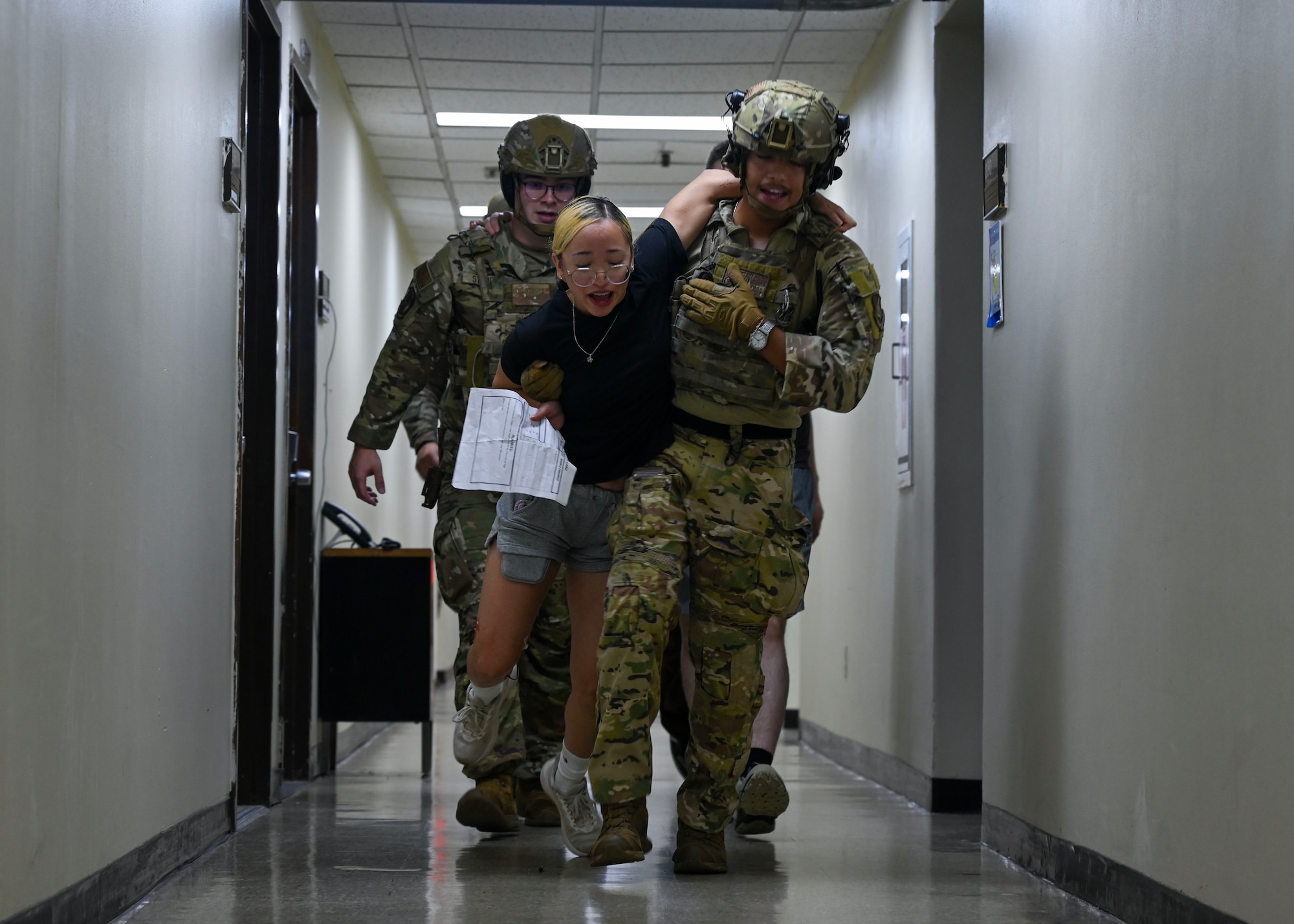 Defenders assigned to the 51st Security Forces Squadron evacuate a simulated casualty for medical treatment during an active shooter exercise at Osan Air Base, Republic of Korea, Sept. 18, 2025. The exercise tested teamwork, communication, and coordination with base-wide emergency response agencies. (U.S. Air Force photo by Staff Sgt. Sarah Williams)