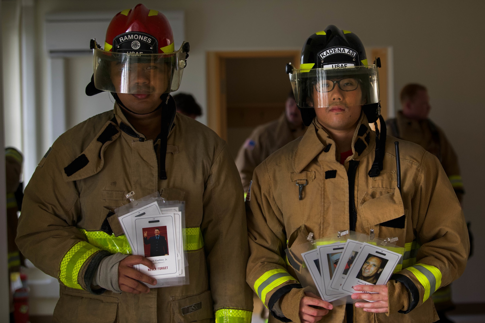Service members holding tags depicting fallen first responders.