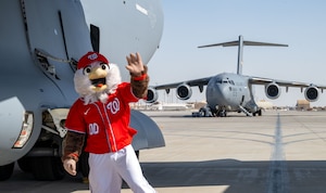Screech, the Washington Nationals mascot, waves in front of a C-17 Globemaster III within the U.S. Central Command area of responsibility, Sept. 13, 2025. Screech is the official mascot of the Nationals and made his debut in 2005. (U.S. Air Force photo by Senior Airman Amanda Jett)