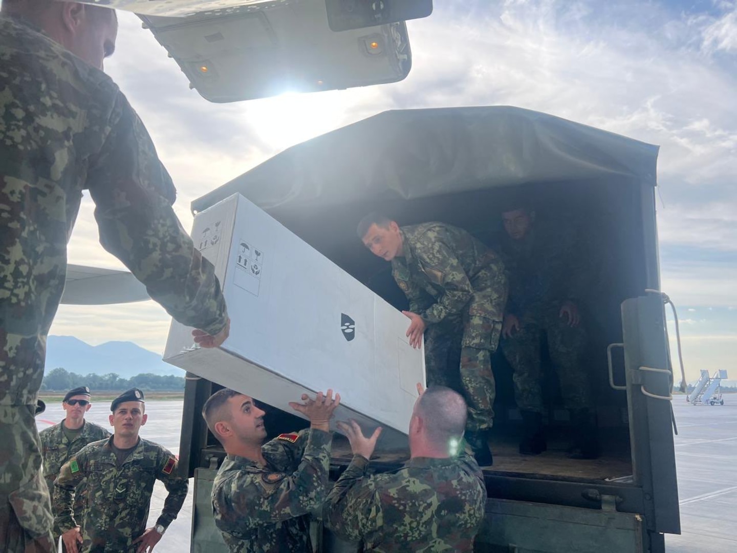 Members of the Albanian Armed Forces receive military equipment from Airmen and Soldiers of the New Jersey National Guard in Tirana, Republic of Albania, September 14, 2025, as part of a key Defense Security Cooperation Agency and National Guard Bureau initiative to use Air National Guard flights for transport of Building Partner Capacity materials to State Partnership Program participants.
