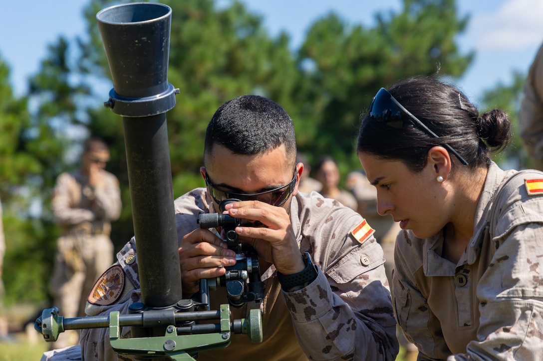 Martin Lopez, center, and Periera Avila, both soldados with Infantería de Marina (Spanish marine corps), adjusts for fire on an M252 81mm mortar system during a live-fire range with U.S. Marines with Weapons Company, 2nd Battalion, 2nd Marine Regiment, as part of exercise UNITAS 2025 at Marine Corps Base Camp Lejeune, North Carolina, Sept. 17, 2025. UNITAS, which is Latin for “unity,” was conceived in 1959 and has taken place annually since first conducted in 1960. UNITAS, which is Latin for “unity,” was conceived in 1959 and has taken place annually since first conducted in 1960. This marks the 66th iteration of the world’s longest running annual multinational maritime exercise. (U.S. Marine Corps photo by Lance Cpl. Jack Labrador)